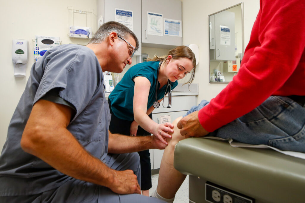 Doctors work with a patient in a clinic setting