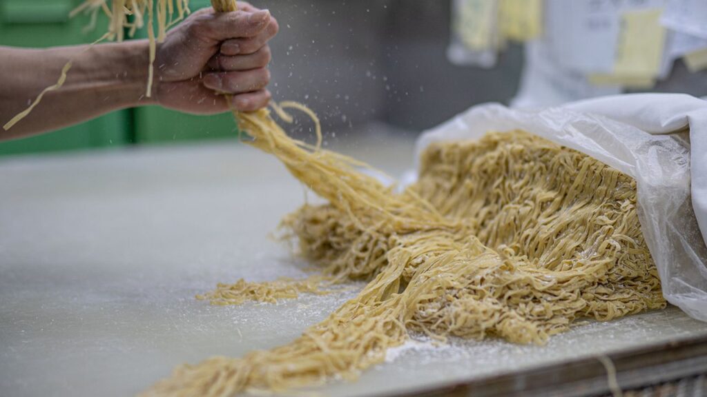 A worker prepares noodles at the Aberdeen Yau Kee Noodles Factory in Hong Kong on January 13, 2023. Credits: Noemi Cassanelli/CNN