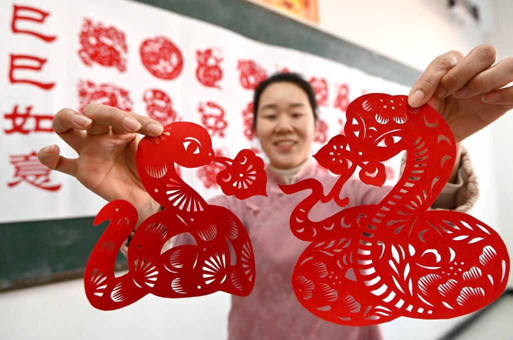 HANDAN, CHINA - JANUARY 17, 2025 - Yin Lingling, an inheritor of intangible cultural heritage paper-cutting, creates paper-cutting of the Year of the Snake, Handan city, Hebei province on Jan 17, 2025. (Photo by CFOTO/Sipa USA)