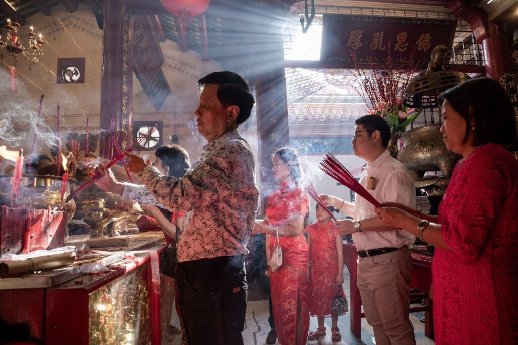 People burn incense at a temple in Yangon, Myanmar on the first day of the Lunar New Year in 2024.