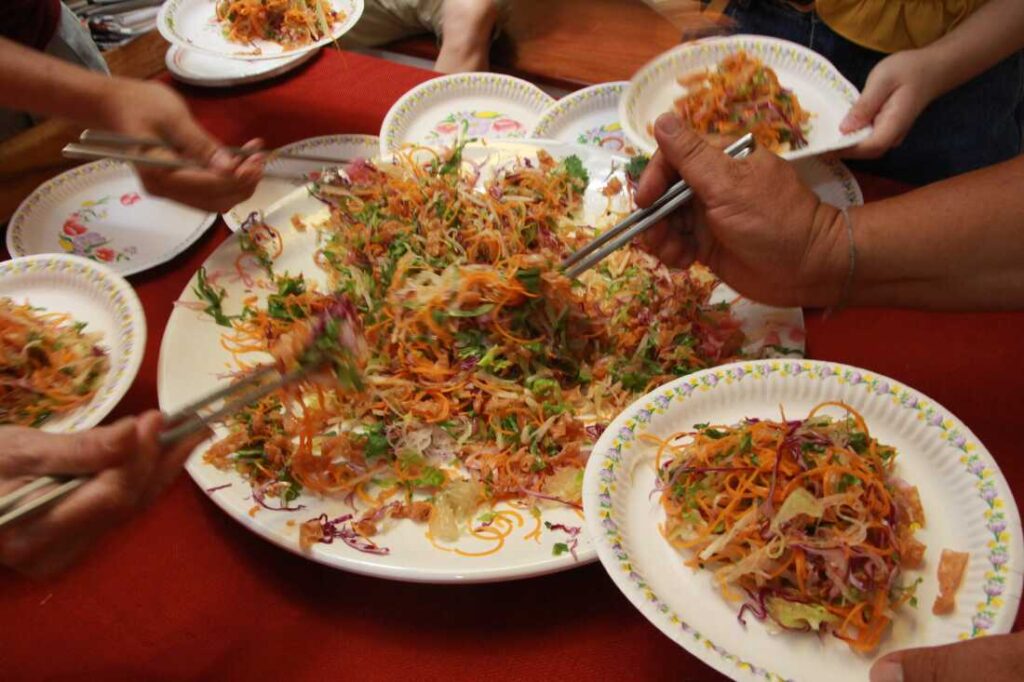 Chelsea Tan and her friends participate in a "prosperity toss" for the Lunar New Year.