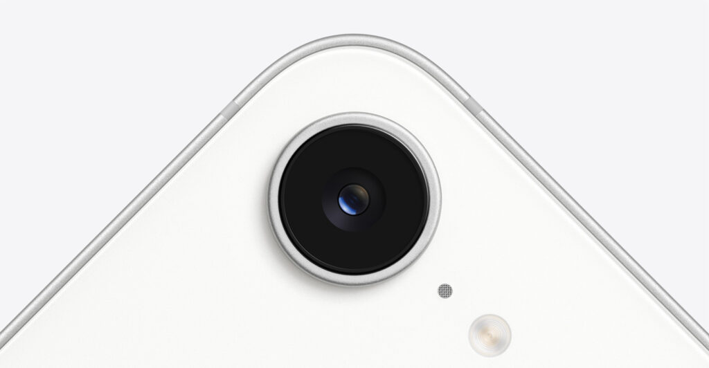 Camera lens on iPhone 16e in color white.