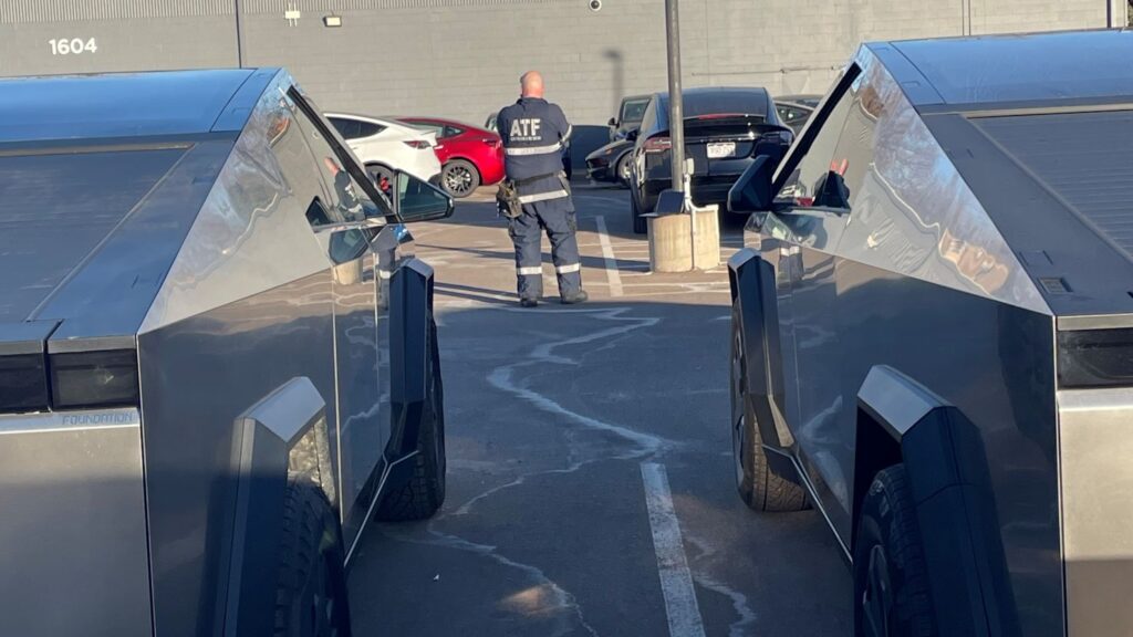 Investigators from the Denver Field Division of the Bureau of Alcohol, Tobacco, Firearms and Explosives are seen at the Tesla dealership in Loveland, Colorado.