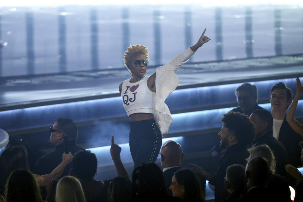 Janelle Monáe, wearing a cropped shirt printed