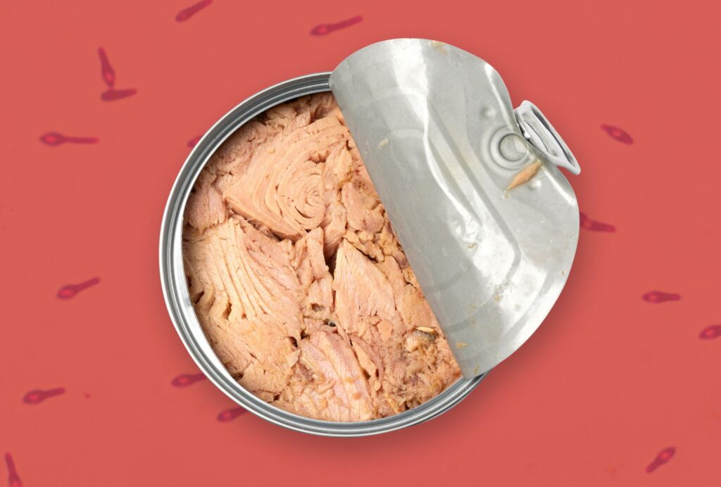 An open can of tuna over a background with a red tinted photomicrograph of Clostridium botulinum.