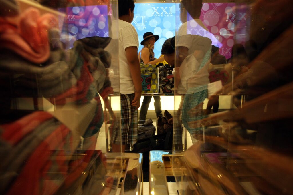 Shopper Cristina Blade, center, carries her recent purchases during the opening of the new Forever 21 store.